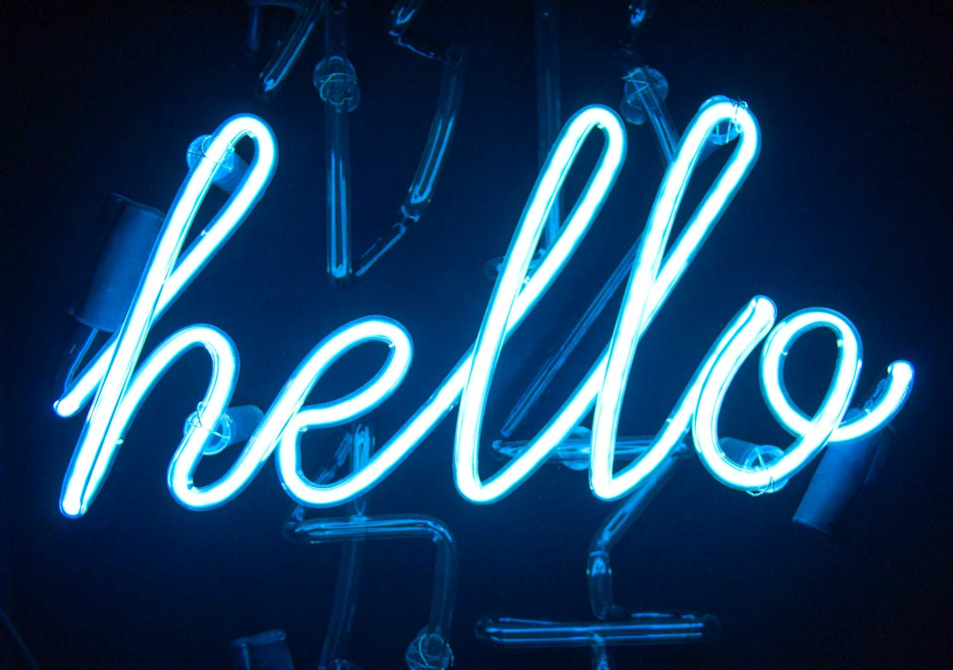 Blue neon sign spelling out hello in a cursive font